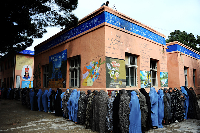 Afghan women queue outside a school to vote in presidential elections in the northwestern city of Herat on April 5, 2014. (AFP Photo / Aref Karimi)