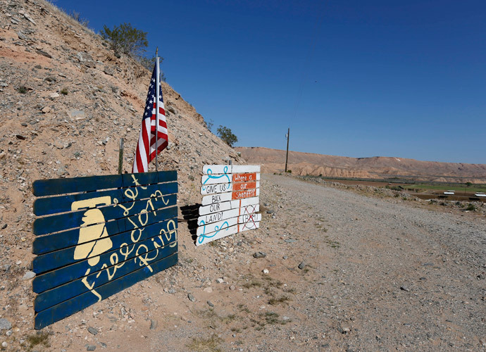 Signs sit at the entrance of a ranch protesting against the Bureau of Land Management's (BLM) decision to temporarily close access to thousands of acres of BLM land to round up illegal cattle that are grazing, south of Mesquite, Nevada, April 7, 2014. (Reuters / George Frey)