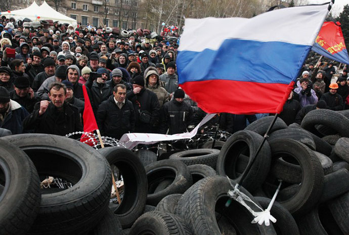 Pro-Russian activists rally at a barricade outside the regional state administration in the eastern Ukrainian city of Donetsk on April 11, 2014. (AFP Photo / Anatolii Stepanov)