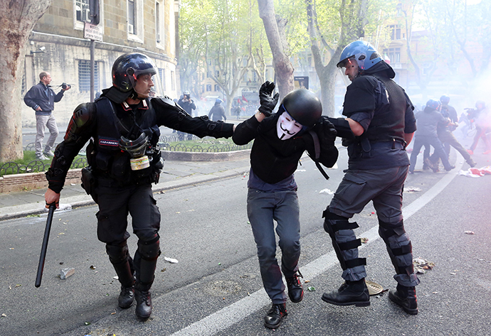 A demonstrator is detained by policemen during a protest in downtown Rome April 12, 2014. (Reuters / Alessandro Bianchi)