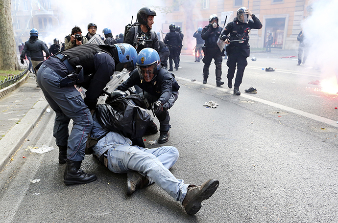 A demonstrator is detained by policemen during a protest in downtown Rome April 12, 2014. (Reuters / Alessandro Bianchi)