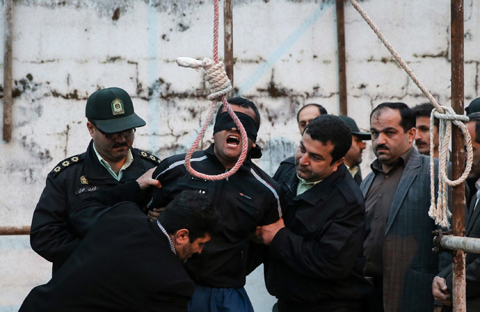 Balal, who killed Iranian youth Abdolah Hosseinzadeh in a street fight with a knife in 2007, is brought to the gallows during his execution ceremony in the northern city of Nowshahr on April 15, 2014. (AFP Photo / Arash Khamooshi / ISNA) 