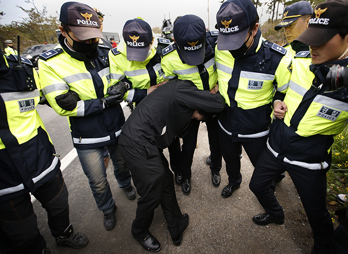 A family member of a passenger missing after the South Korean ferry "Sewol" capsized is blocked by police during a protest in Jindo calling for a meeting with President Park Geun-hye and demanding the search and rescue operation be speeded up, April 20, 2014. (Reuters / Kim Kyung Hoon)