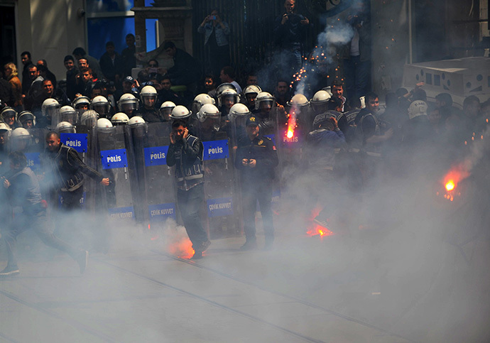 Fenerbahce and Besiktas throw flares at the police as they protest against a new system of e-tickets on April 20, 2014, on Istiklal Avenue in Istanbul. (AFP Photo / Ozan Kose)
