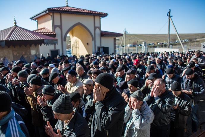 Crimean Tatars pray during a traditional funeral ceremony at the Abdal Muslim Cemetery in Simferopol. (RIA Novosti/Andrey Stenin)