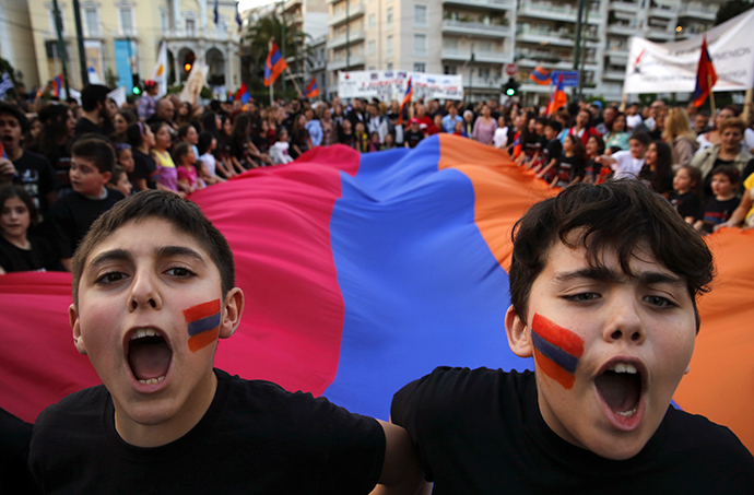 Armenian boys shout slogans against Turkey in front of a huge Armenian flag during a demonstration near the Turkish embassy in central Athens, April 24, 2013. (Reuters / Yannis Behrakis)