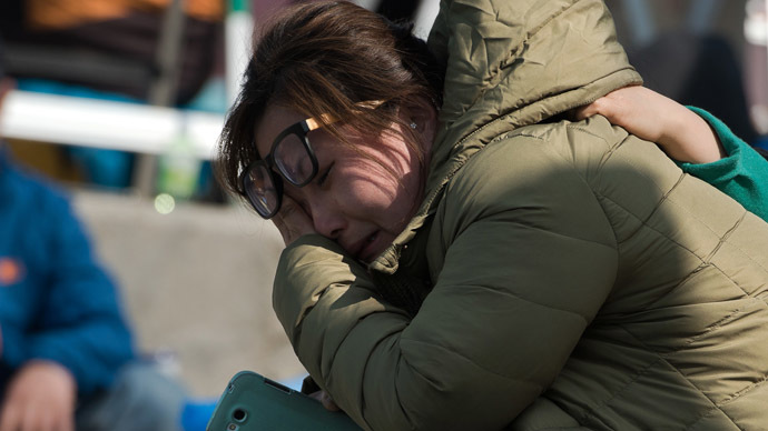 A woman reacts after the body of a relative was recovered and identified from the capsized South Korean ferry "Sewol" at an area where family members of victims of the disaster are gathered at Jindo harbour (AFP Photo/Nicolas Asfouri)