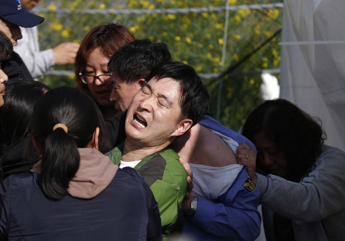 Angry family members of missing passengers onboard the capsized Sewol ferry drag Choi Sang-hwan, deputy head of the South Korean coast guard (2nd R), and a government official (C) out from their office to demand for faster and more efficient rescue work at a port where many family members are waiting for news from the search and rescue team in Jindo April 24, 2014. (Reuters/Kim Kyung-Hoon)