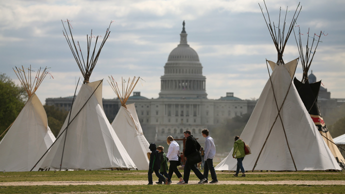 People walk past Indian Teepees that are on the National Mall as part of a protest against the Keystone pipeline April 23, 2014 in Washington, DC (AFP Photo / Mark Wilson)
