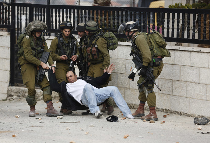 Israeli soldiers drag a Palestinian as they detain him during clashes with stone-throwing Palestinian protesters at a weekly demonstration against the West Bank Jewish settlement of Beit El, in Jalazoun refugee camp, near Ramallah (Reuters)