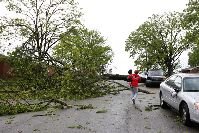 A resident walks by a downed tree along Madison Street after a tornado went through Tupelo, Mississippi April 28, 2014. (Reuters / Lauren Wood)