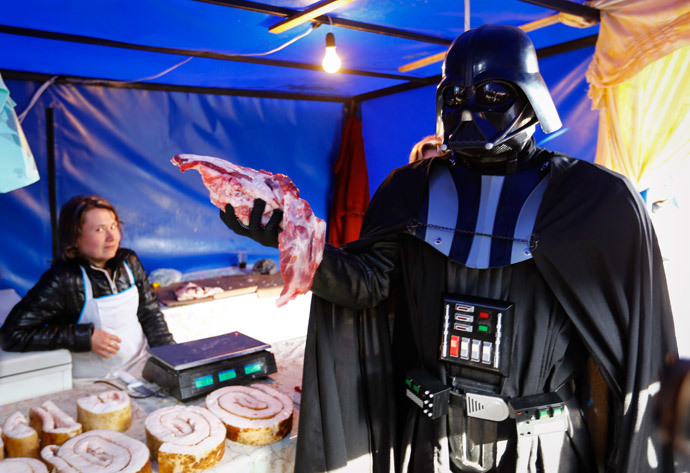 "Darth Vader" holds a piece of meat at a street market in Kiev (Reuters / Shamil Zhumatov)