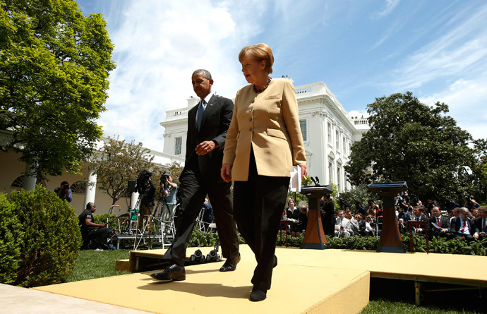 U.S. President Barack Obama and German Chancellor Angela Merkel walk from the Rose Garden after speaking to reporters about their earlier meeting at the White House in Washington May 2, 2014. (Reuters / Kevin Lamarque)