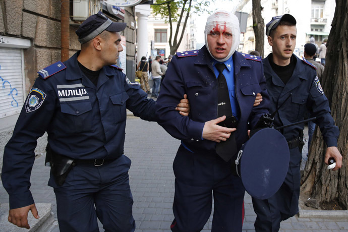 Ukrainian police help an injured colleague during clashes between pro-Russian activists and supporters of the Kiev government in the streets of Odessa May 2, 2014. (Reuters/Yevgeny Volokin)