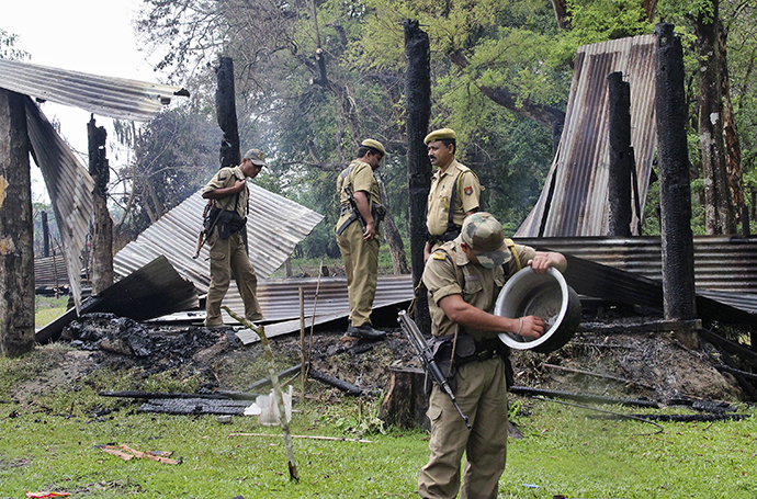 Indian security personnel inspect the debris of the houses that were burnt during attacks at Baksa district in the northeastern Indian state of Assam May 3, 2014. (Reuters)
