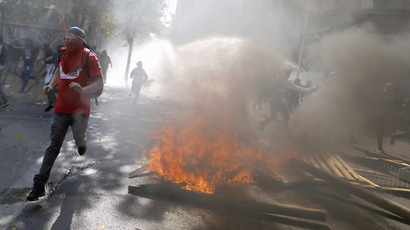 Chilean activist sets fire to $500 mn worth of student debt documents