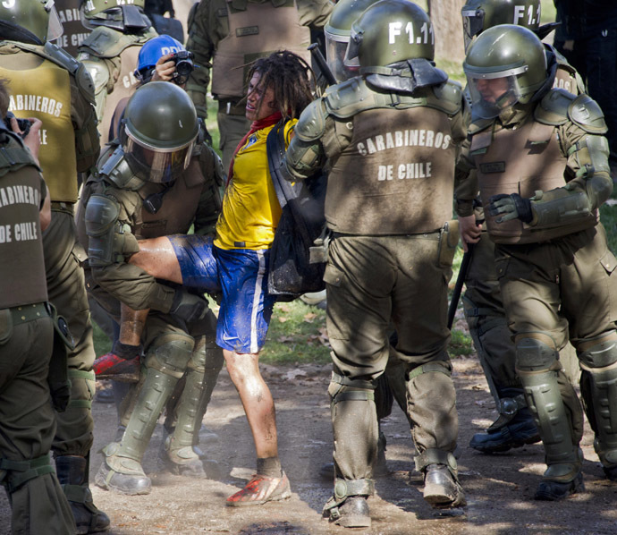Riot police arrest a student who was taking part in a protest against the education system, in Santiago, on May 8, 2014. (AFP Photo)