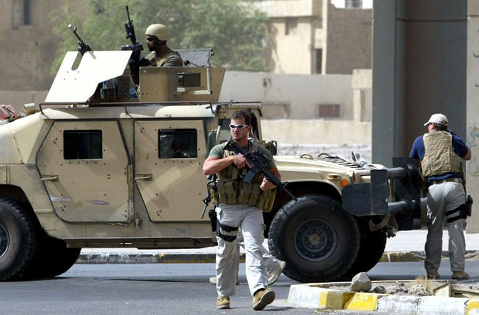 (FILES) A picture taken on July 5, 2005 shows contractors of the US private security firm Blackwater securing the site of a roadside bomb attack near the Iranian embassy in central Baghdad. (AFP Photo / Ahmad Al-Rubaye)