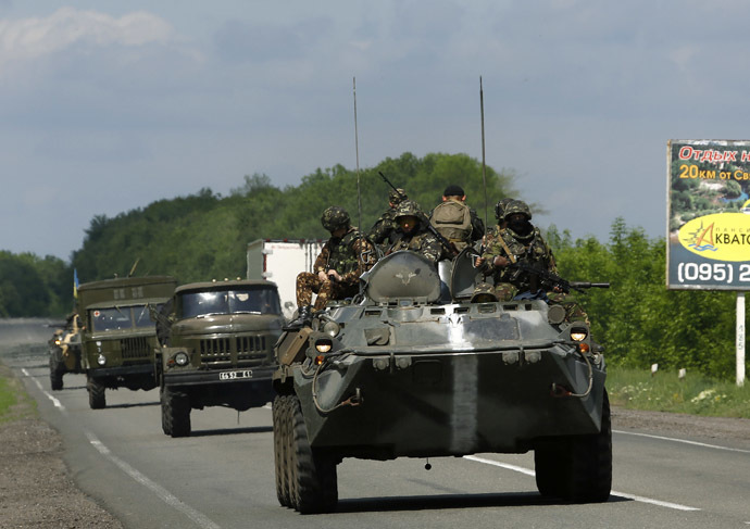 Ukrainian army armoured fighting vehicles and ambulances drive towards the eastern Ukrainian town of Slaviansk May 13, 2014. (Reuters/Yannis Behrakis)