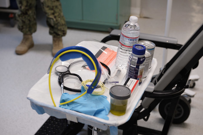 This photo reviewed by the US military and made during an escorted visit shows a US naval medic explaining the "feeding chair" procedures at the detention facility in Guantanamo Bay, Cuba.(AFP Photo / Mladen Antonov)
