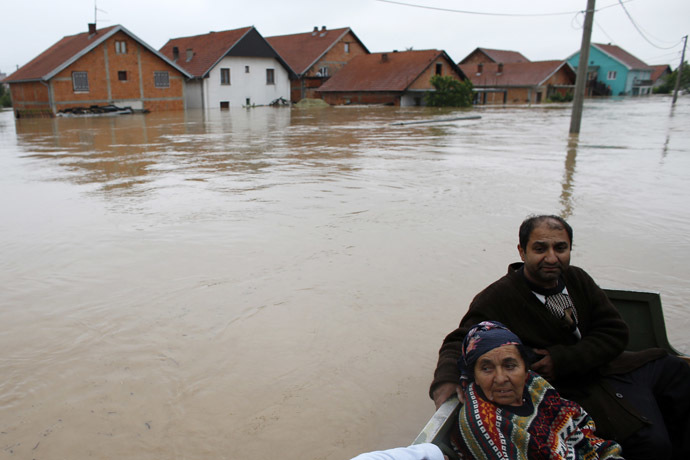 People sit in a boat after being evacuated from their flooded houses in the town of Obrenovac, east from Belgrade May 16, 2014. (Reuters/Marko Djurica)