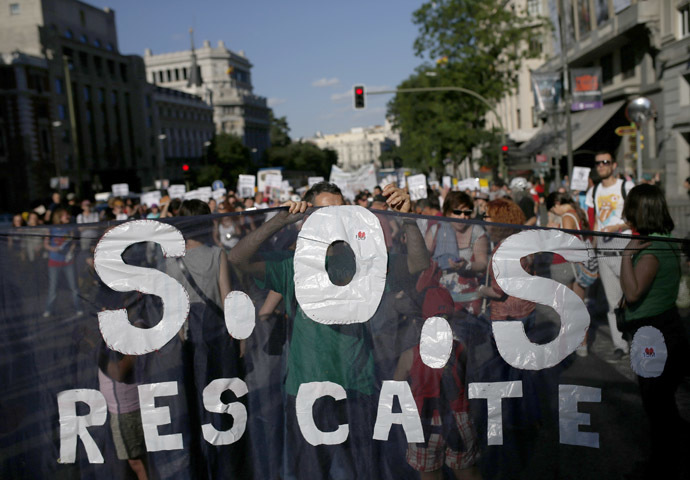 Demonstrators shout slogans, while arriving to the Puerta del Sol on the third anniversary of the 15M movement in central Madrid May 17, 2014. (Reuters/Javier Barbancho)