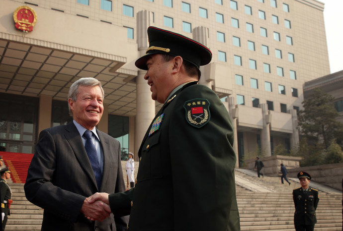 Chinese Minister of Defense Chang Wanquan (R) shakes hands with US Ambassador to China Max Baucus (L).( AFP Photo / Alex Wong )