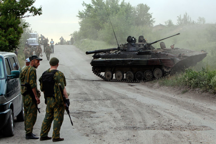 Pro-Russian activists stand near an armoured fighting vehicle (AFV) that they said was captured from the Ukrainian army during a fight outside the eastern Ukrainian town of Lysychansk May 22, 2014.(Reuters / Valentyn Ogirenko)