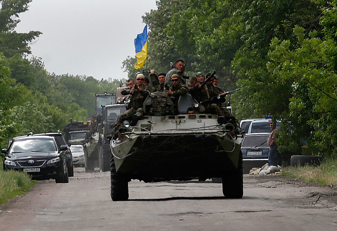 Ukrainian soldiers ride atop an armored personnel carrier, south of Donetsk (Reuters / Yannis Behrakis)