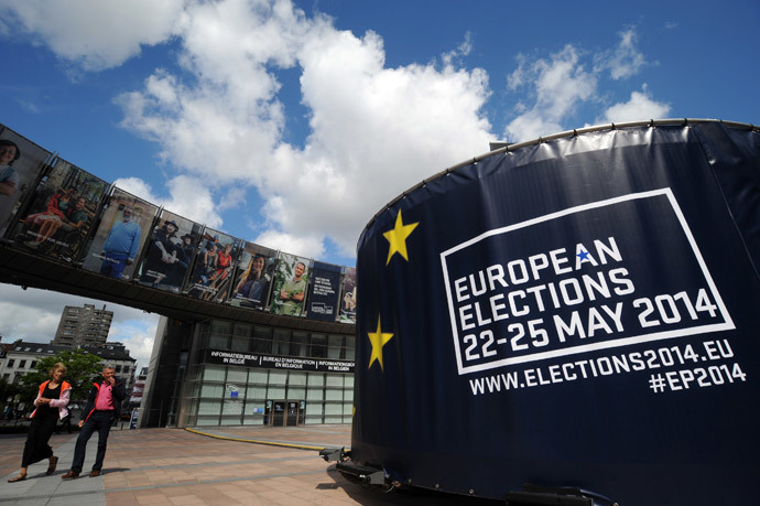 People walk in front of visuals promoting the European elections in front of the European Parliament in Brussels (Reuters / Eric Vidal)