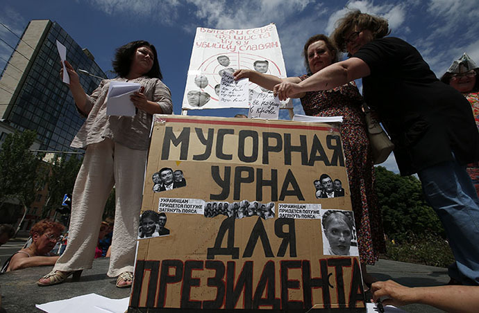 People cast votes in a mock ballot box that reads "Rubbish bin for the President" during an anti-election rally in the eastern city of Donetsk May 25, 2014. (Reuters / Maxim Zmeyev)