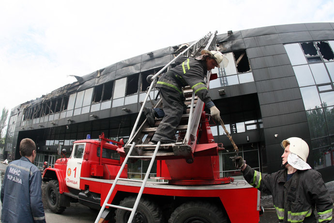 Firemen work on the damaged Druzhba Hockey Arena inthe eastern Ukrainian city of Donetsk, burned by unknown armed men, after they extinguished the fire on May 27, 2014. (AFP Photo / Alexander Khudoteply)