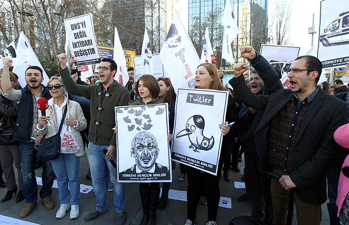 People hold placards as they protest against Turkey's Prime Minister Tayyip Erdogan after the government blocked access to Twitter in Ankara, on March 21, 2014. (AFP Photo / Adem Altan)