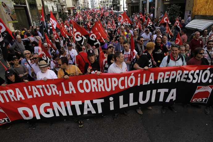 Demonstrators of the General Confederation of Work (CGT) march during May Day celebrations in Valencia May 1, 2014. The banner reads, "Against unemployment, corruption and repression. Dignity and struggle". (Reuter/Heino Kalis)