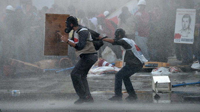 Anti-government protesters try to protect themselves from water cannons used by riot police to disperse them in Ankara May 31, 2014.(Reuters / Stringer)