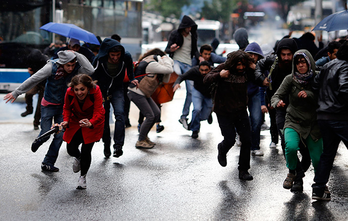 People run a way from tear gas fired during clashes between riot police and demonstrators during a protest in central Ankara June 1, 2014. (Reuters / Umit Bektas)
