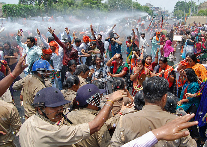 Supporters of Bharatiya Janata Party (BJP) shout slogans as police use a water cannon to stop them from moving towards the office of Akhilesh Yadav, the chief minister of the northern Indian state of Uttar Pradesh, during a protest against recent rape and hanging of two girls, in Lucknow June 2, 2014. (Reuters / Pawan Kumar) 