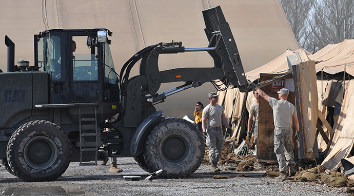US servicemen use a lift truck as they dismantle the tent camp at the US transit center in Manas, 30 kilometers outside Kyrgyzstan's capital Bishkek on March 6, 2014 (AFP Photo / Vyacheslav Oseledko)