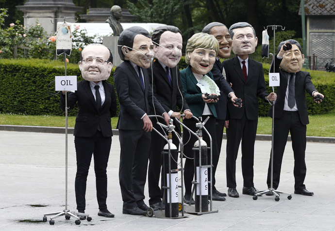 Oxfam activists wear masks depicting leaders of the countries members of the G7 during a protest called "Energy dependency and wealth inequality" outside the European Council in Brussels June 3, 2014. (Reuters/Yves Herman)