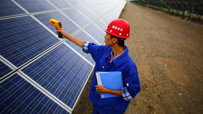 A worker inspects solar panels at a solar farm in Dunhuang, 950km (590 miles) northwest of Lanzhou, Gansu Province (Reuters/Carlos Barria)