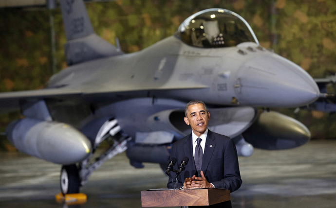 With an F-16 fighter in the background, U.S. President Barack Obama makes remarks upon his arrival in Warsaw June 3, 2014. (Reuters/Kevin Lamarque)