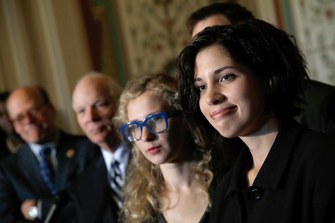 Nadya Tolokonnikova (R) and Maria Alyokhina (C), members of the Russian punk protest group Pussy Riot, answer questions after meeting with U.S. senators, including Sen. Ben Cardin (D-MD) (L) at the U.S. Capitol May 6, 2014 in Washington, DC. (Win McNamee / Getty Images / AFP) 