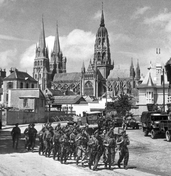 British soldiers march past the town of Bayeux, one of the first towns to be liberated in the Normandy landings. (AFP Photo)
