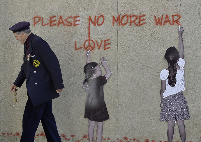 : An 88-year old British D-Day veteran Paul Butler passes along a wall mural at Arromanches-les-Bains on the Normandy coast with a graffiti saying âPlease, no more warâ (Reuters / Toby Melville)