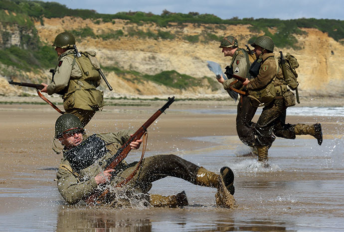History enthusiasts wearing WW2 US military uniforms in D-Day landing re-enactment on Omaha Beach in Vierville-Sur-Mer, on the Normandy Coast on June 5 2014. (Reuters / Pascal Rossignol)