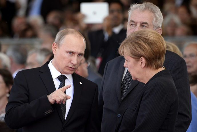 Russian President Vladimir Putin and German Chancellor Angela Merkel chat at the international D-Day commemoration ceremony in Normandy, on June 6, 2014, marking the 70th anniversary of the World War II Allied landings in Normandy. (AFP Photo / Alain Jocard)