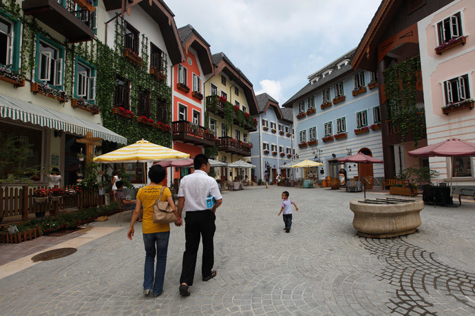 A family walks in the Chinese replica of Austria's UNESCO heritage site, Hallstatt village, in China's southern city of Huizhou in Guangdong province (Reuters / Tyrone Siu)