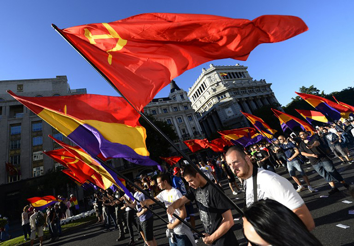 People hold flags of the Spanish Second Republic and communist flags during a demonstration to demand a referendum on the monarchy following the abdication of King Juan Carlos, in Madrid on June 7, 2014. (AFP Photo / Gerard Julien)