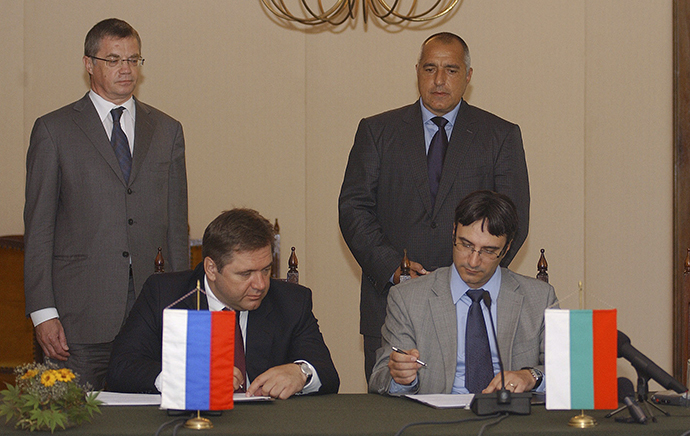Bulgarian former Prime Minister Boiko Borisov (rear R) and Russia's Gazprom Deputy Chairman Alexander Medvedev (rear L) watch as Bulgarian former Economy and Energy Minister Traicho Traikov (front R) and Russia's former Energy Minister Sergei Shmatko sign documents during an official ceremony in the city of Varna, some 450km (280miles) north-east of Sofia July 17, 2010. (Reuters)