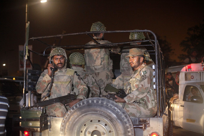 Pakistan Army soldiers sit on a vehicle as they arrive at Jinnah International Airport in Karachi June 9, 2014. (Reuters/Athar Hussain)